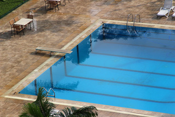 A clean open swimming pool with a plank