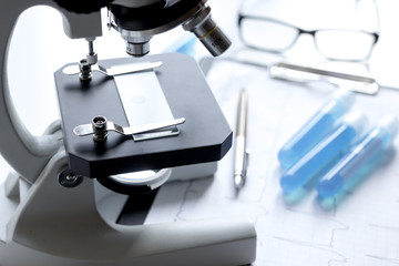 doctors desk with microscope and test tubes