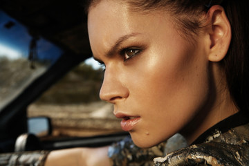 Woman warrior in futuristic clothes with car