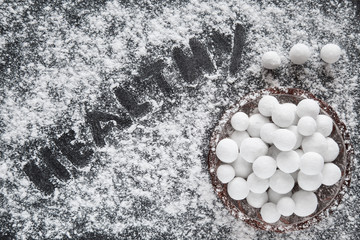 Cranberries from forest frozen on winter time in the powdered sugar. Balls of cranberries in the glass bowl.