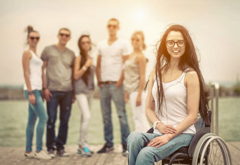 Young people on the pier with them disabled friend.