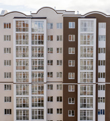 Wall of a residential block of flats with balconies windows