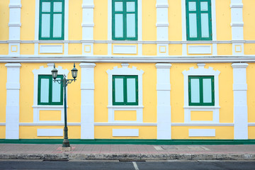 Streetlights and yellow wall