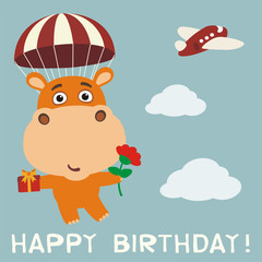 Happy birthday! Funny hippo fly on parachute with gift and flower. Birthday card with hippopotamus in cartoon style.