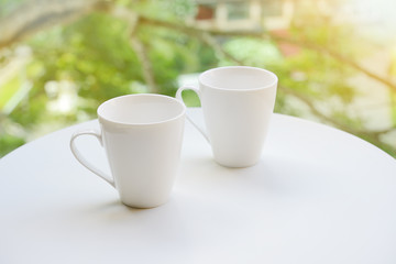 Cup,Two cup, of tea or coffee on table on garden bright backgrou