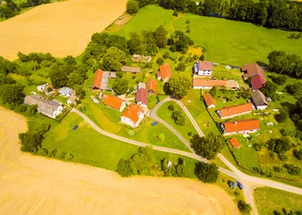 Deurstickers Luchtfoto Aerial view of small village in central Bohemia. Farms with beautiful gardens and fields in agricultural landscape. Living on Countryside, Czech Republic, Europe.