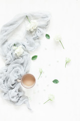 Composition with coffee and white flowers. Flat lay, top view