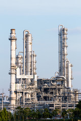Refinery tower in petrochemical industrial plant with cloudy sky