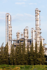 Refinery tower in petrochemical industrial plant with cloudy sky