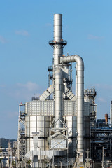 Refinery tower in petrochemical industrial plant with cloudy sky