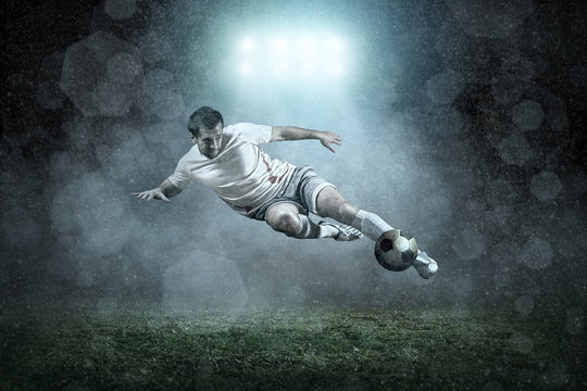 Soccer player with ball in action outdoors