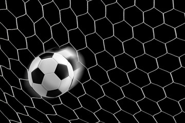 soccer ball in goal net isolated on black background