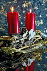 Candlestick out of twigs decorated with candles and cloth hearts.