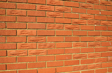 Obraz premium Fish shapes in the bricks of a wall in Bridlington, UK.
