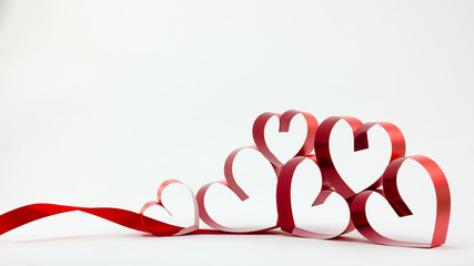 Ribbons shaped as hearts on white background, valentine day conc