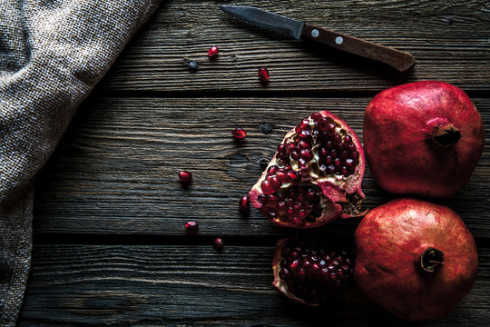 Fresh pomegranates on a wooden background. Organics, fruit, food