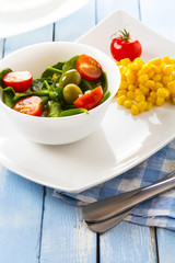 spinach tomato salad food fresh healthy cook rustic wooden background
