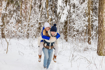The guy and the girl have a rest in the winter woods.