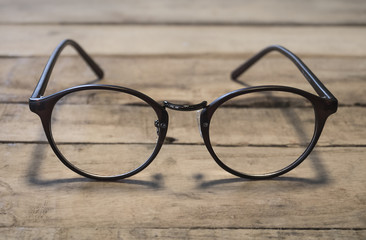 eyeglasses on wood table