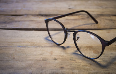 Fototapeta na wymiar eyeglasses on wood table