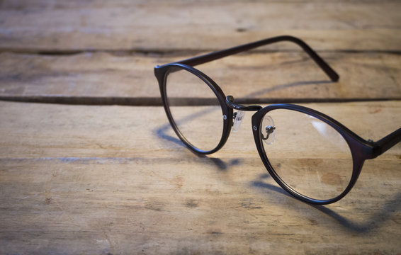 eyeglasses on wood table