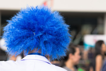Close up a clown's blue hair.