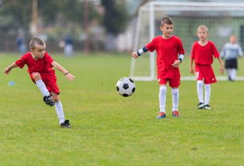 Obraz premium Boys kicking ball