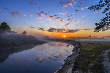 Beautiful sunrise on river with fog