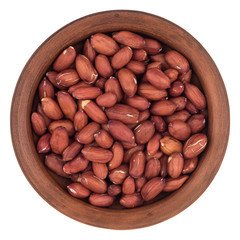 Peanuts in a brown plate. Isolated on white background.