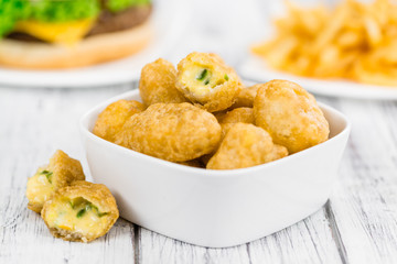 Wooden table with Chili Cheese Nuggets (selective focus)