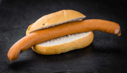Sausages (Frankfurter) on a vintage slate slab (selective focus)