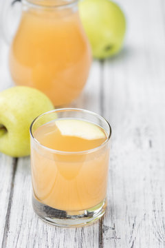 Fresh made Apple Juice on a rustic background