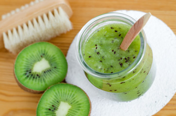 Fototapeta na wymiar Homemade kiwi fruit beauty mask (scrub) in a glass jar. DIY cosmetics.