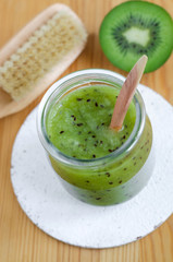 Homemade kiwi beauty mask (scrub) in a glass jar. DIY cosmetics.