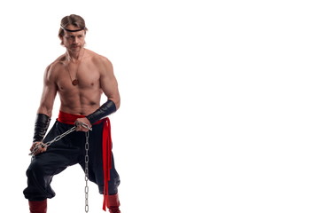 portrait of actor athlete man in trousers with naked torso training with chain on white background