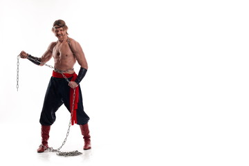 Actor Athlete man in trousers with naked torso training with chain on white background