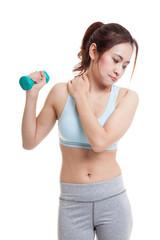 Asian healthy girl got shoulder pain with dumbbell.