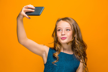 Fototapeta premium The face of playful happy teen girl with phone