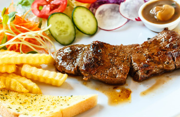 Beef steak with black pepper sauce and vegetables.