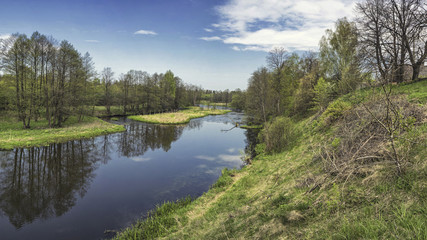 Spring river flowing in a valley. Stitched Panorama