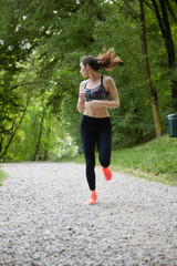 Young attractive sport girl running  in park