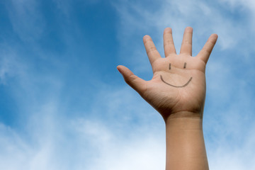 Happy smiling face on hand with a good feeling