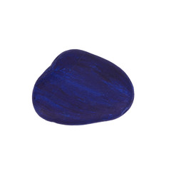 A dark blue painted pebble stone isolated on a white background
