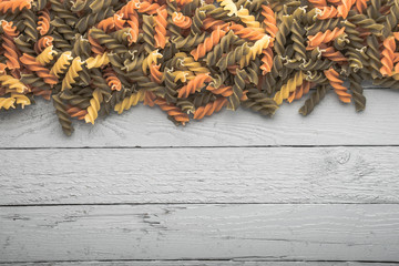 fussili pasta on retro wooden background. With copy space.