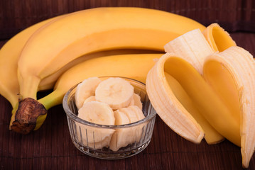 Bananas. Whole, half and cut in a bowl