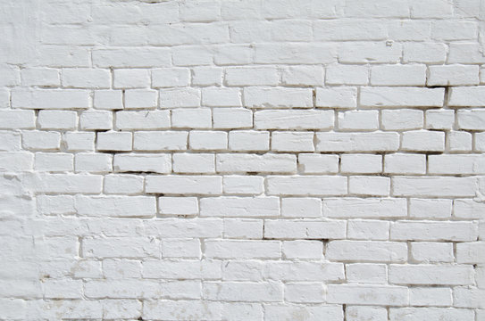 Texture of old white and gray brick wall surface with cement and concrete seams
