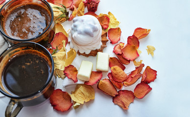 Valentine's Day. Tasty dessert. Morning coffee with rose petals. Cakes, coffee, rose petals on white background, space for text, heart of rose petals. Love, care for the beloved