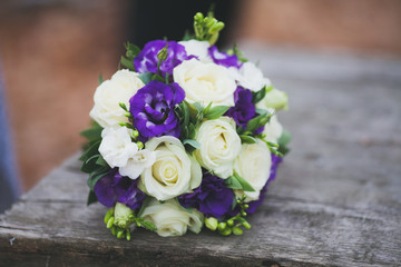 bride bouquet on wooden table, white violet colours