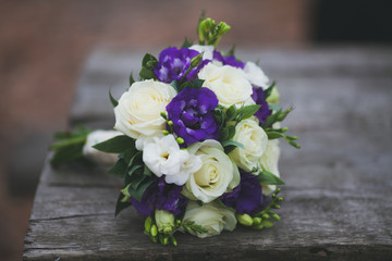bride bouquet on wooden table, white violet colours