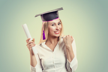 graduated student celebrating being a winner holding diploma scroll